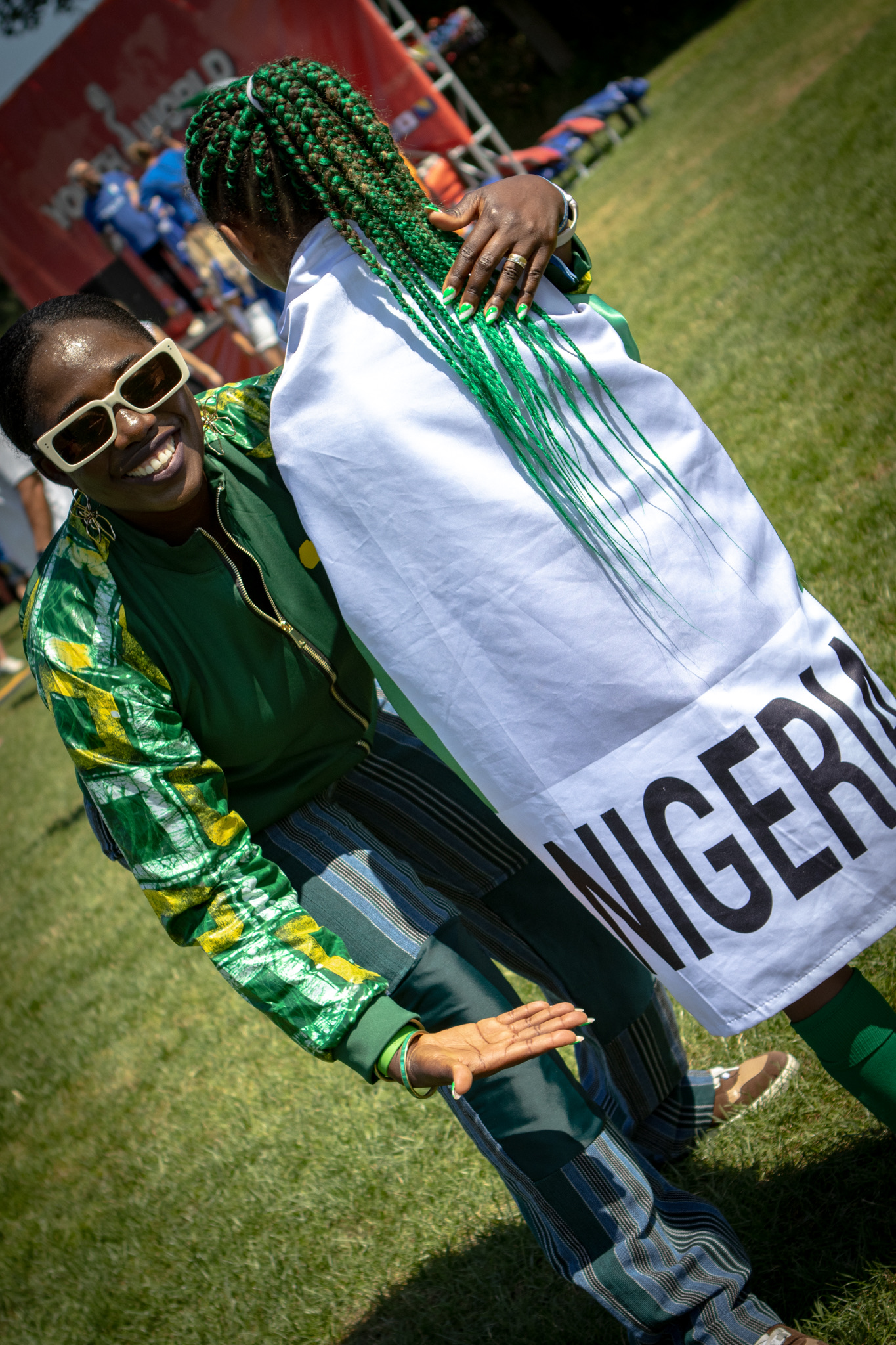 Bisi hugging Liza wrapped in the Nigerian flag at YWC