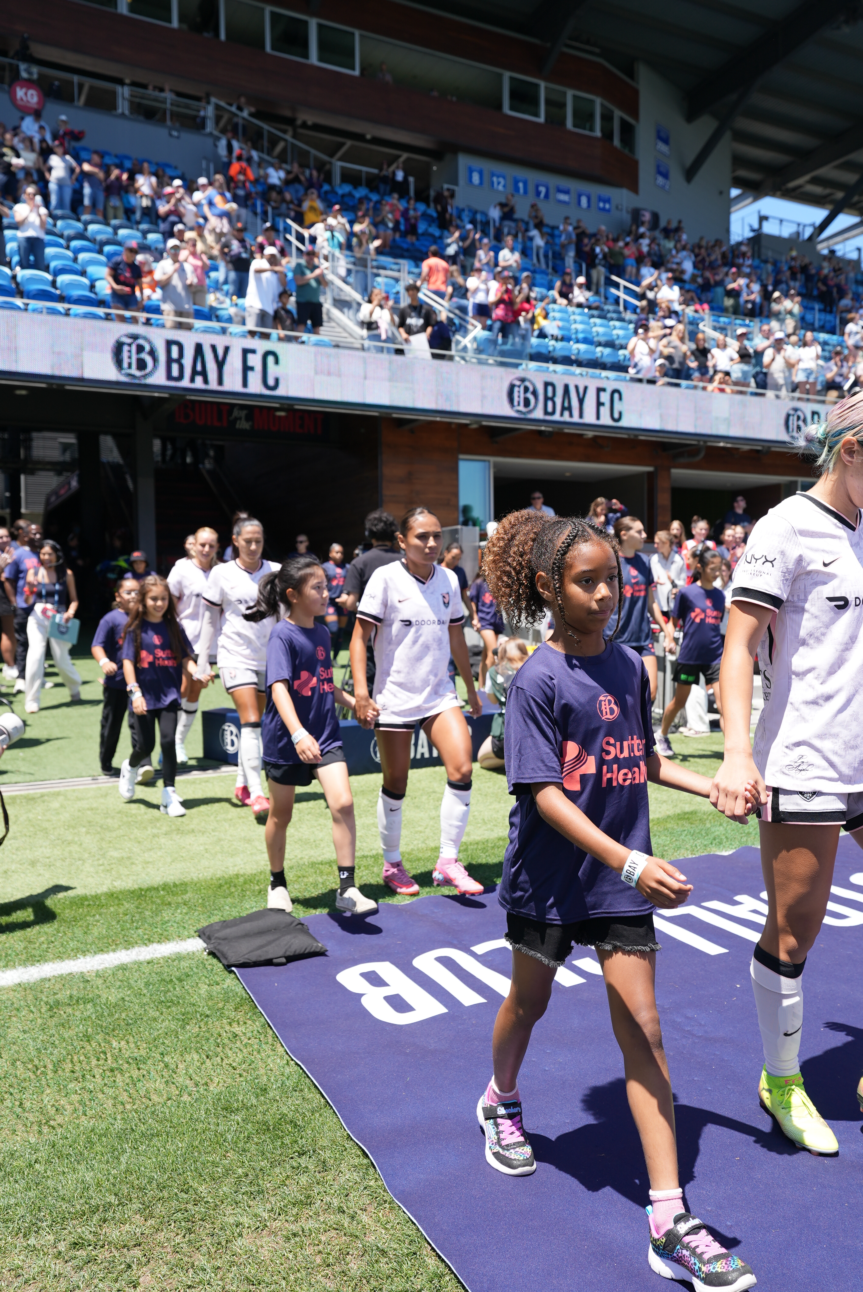 Liza walking out as player escort at USWNT vs Brazil